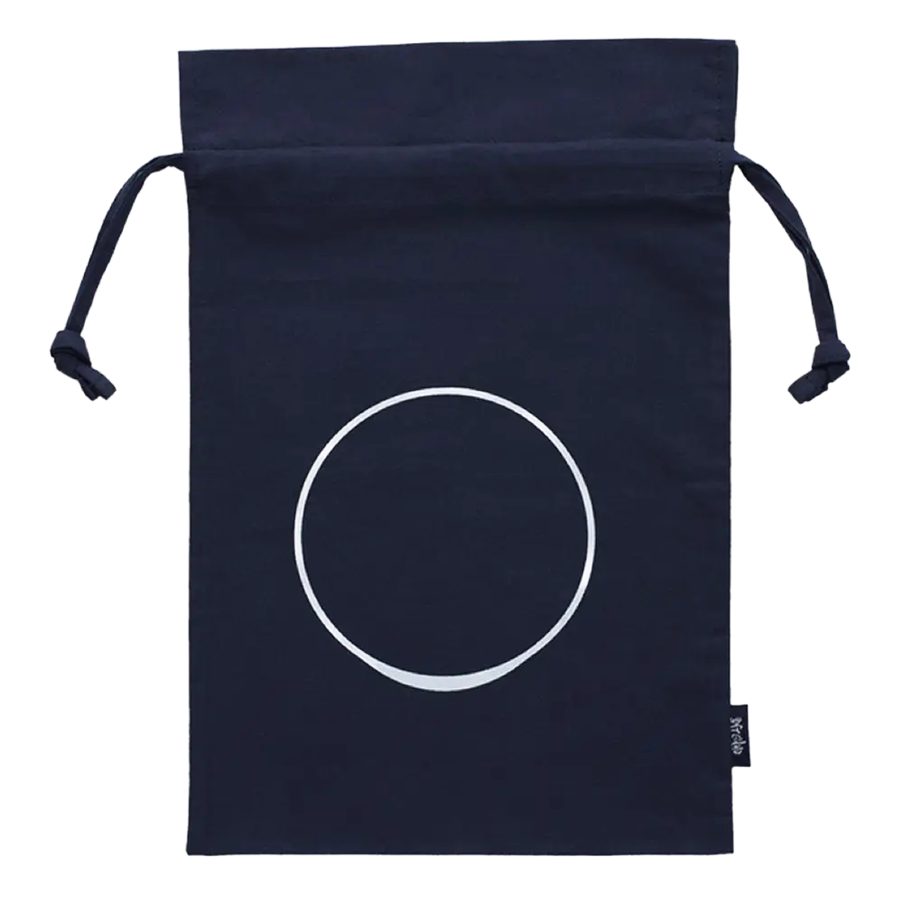 The Custom Umami Gift Bag - Medium by Kayanoya USA features navy organic cotton, a white circle design, and a black side tag—ideal as a personalized gift bag for Kayanoya Dashi Stock or other special treats.