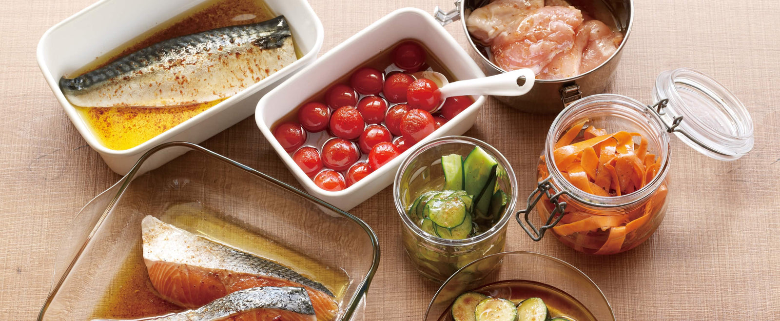 Various marinated seafood and vegetables in glass and ceramic containers on a wooden table.