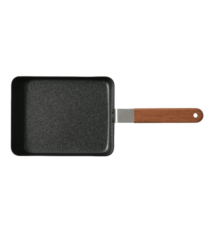The Iron Egg Pan by Kayanoya USA - Kubara Honke USA, Inc. is a rectangular black pan with a textured surface and wooden handle, ideal for making Japanese omelettes, pictured on a plain white background.