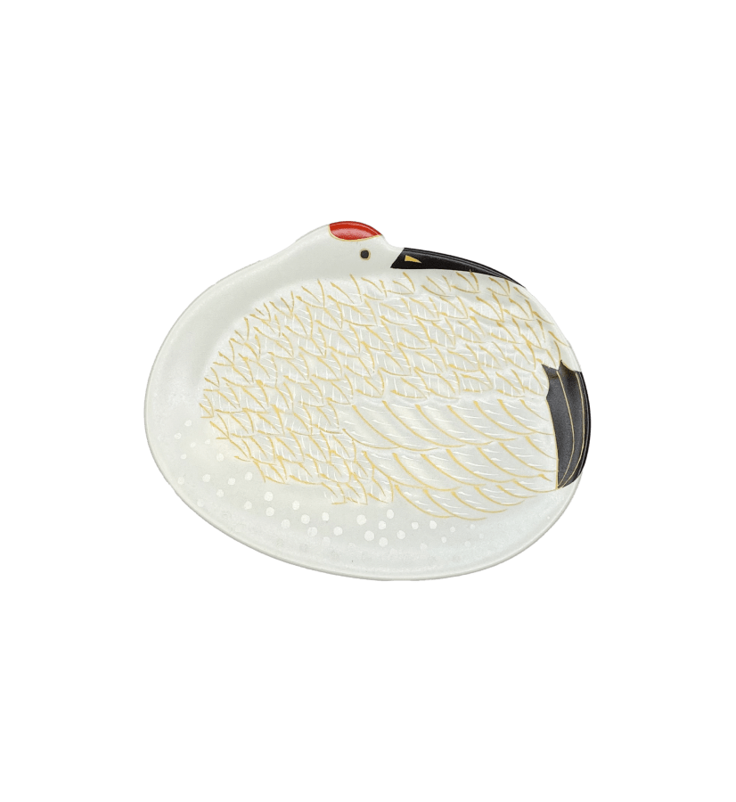 The Kayanoya USA - Kubara Honke USA, Inc. Soy Sauce Dish is an oval ceramic dish shaped and painted like a white swan with gold feather accents, a red spot on the head, black beak, and a crane motif on a plain white background.