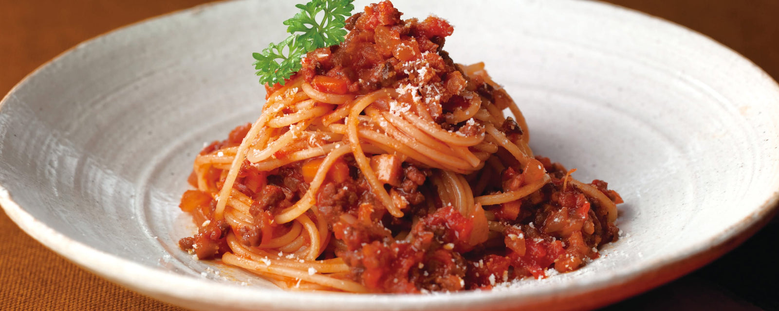 Spaghetti with meat sauce (Bolognese) garnished with parsley