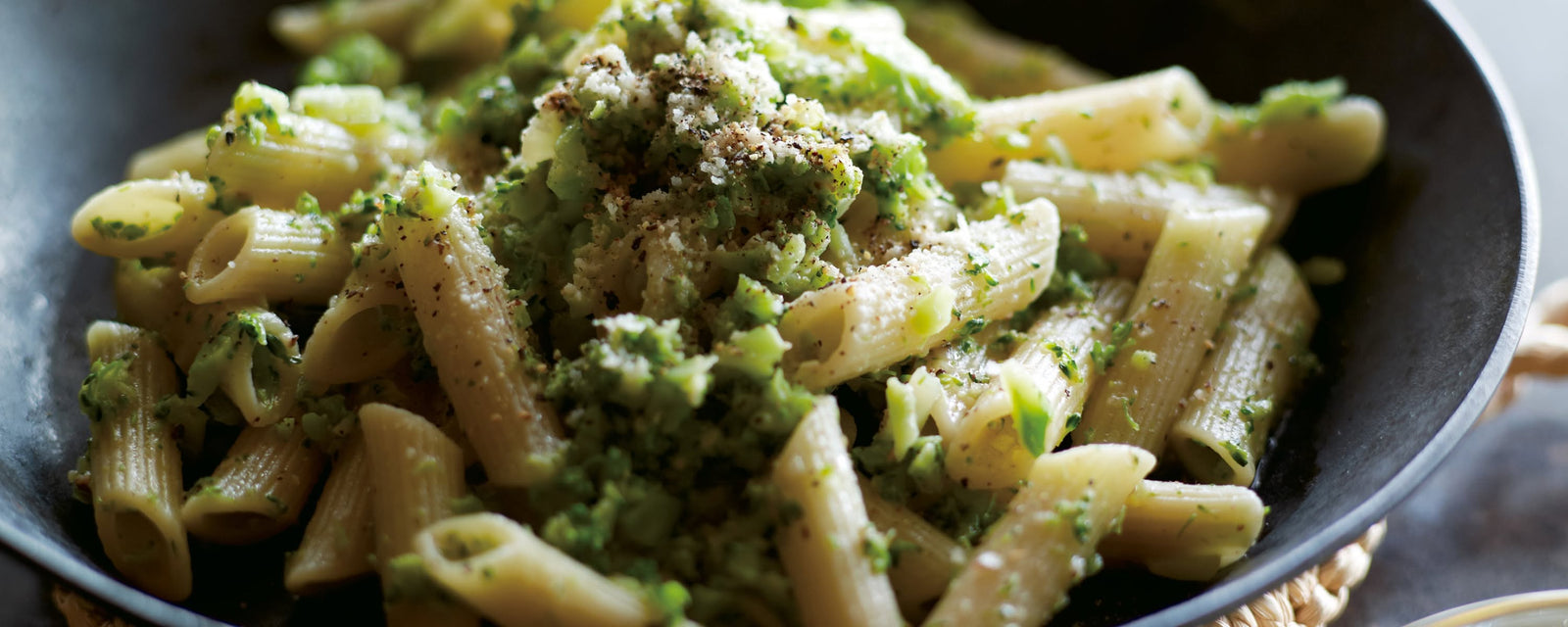 Penne pasta with broccoli and grated cheese