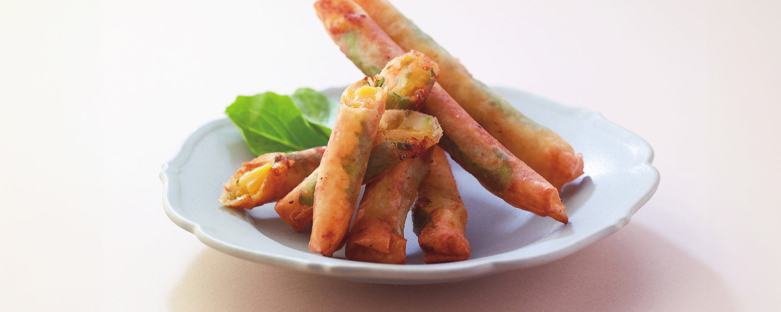 A plate of mango and shiso spring rolls served as a crispy appetizer.