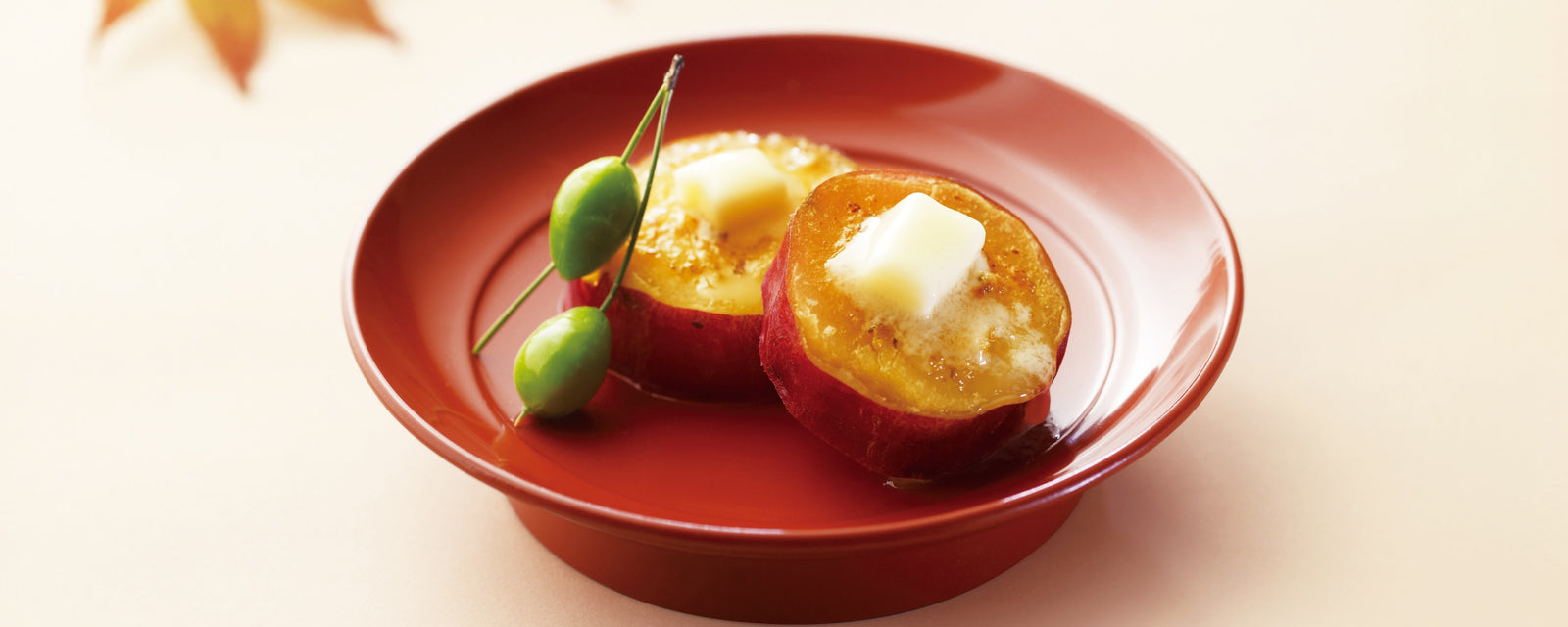 Sweet potato topped with dashi butter served in a small bowl.