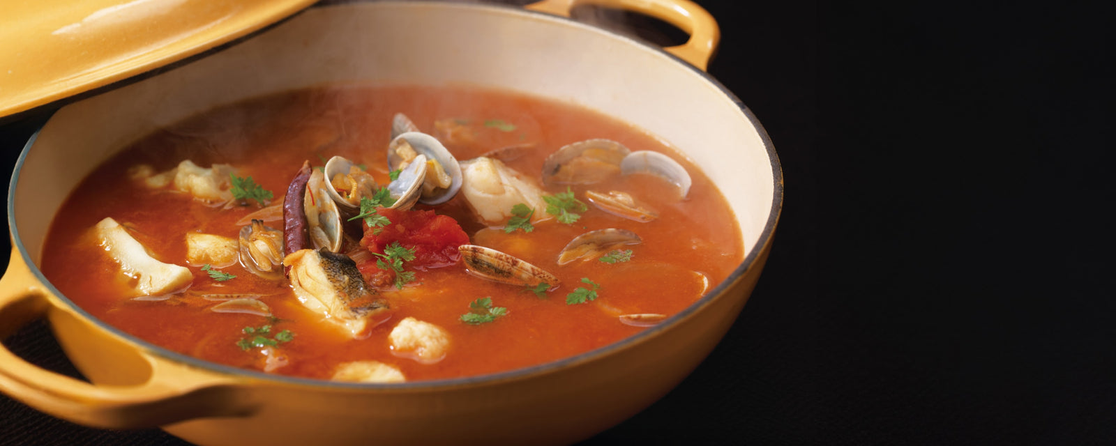 Bouillabaisse with fish and shellfish simmered in a tomato-based broth.