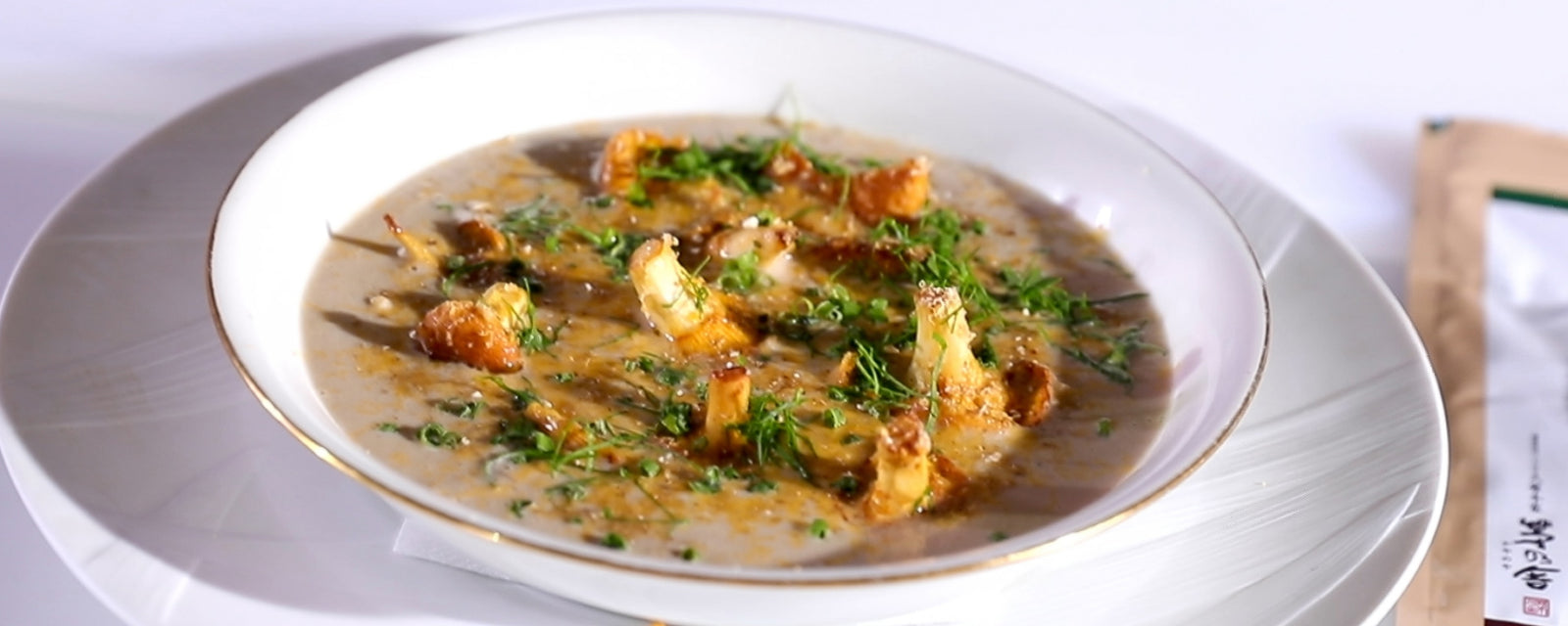 Creamy mushroom potage topped with sautéed mushrooms and fresh herbs.