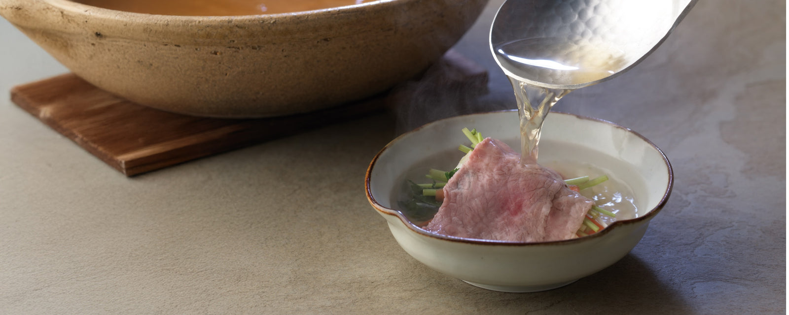 Dashi shabu with thinly sliced beef and vegetables, finished with hot broth poured over.