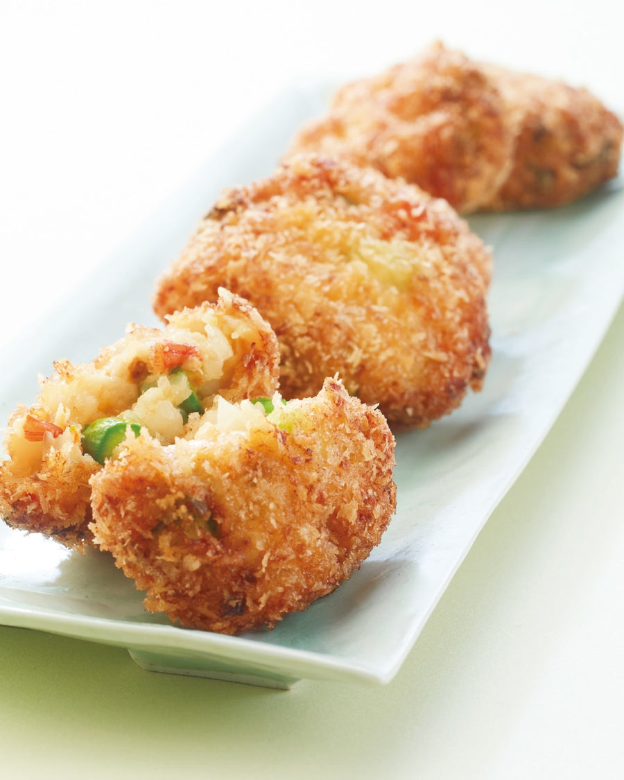 Crispy golden-brown Asparagus and Shrimp Cutlets (Ebi-Katsu) served on a plate, showing a glimpse of green asparagus and plump pink shrimp inside.