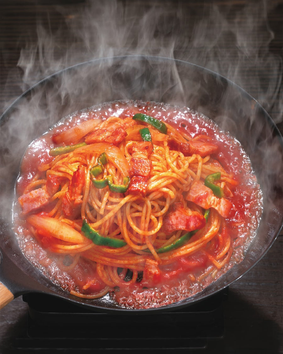 Glossy Spaghetti Napolitan with thick bacon, peppers, and onions in a tomato ketchup sauce.