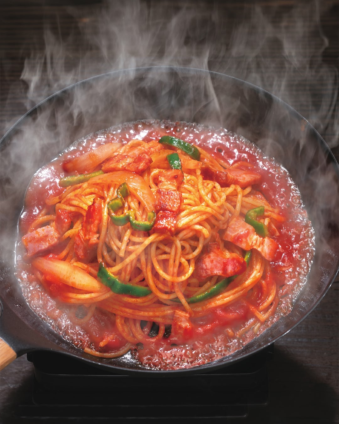 Glossy Spaghetti Napolitan with thick bacon, peppers, and onions in a tomato ketchup sauce.