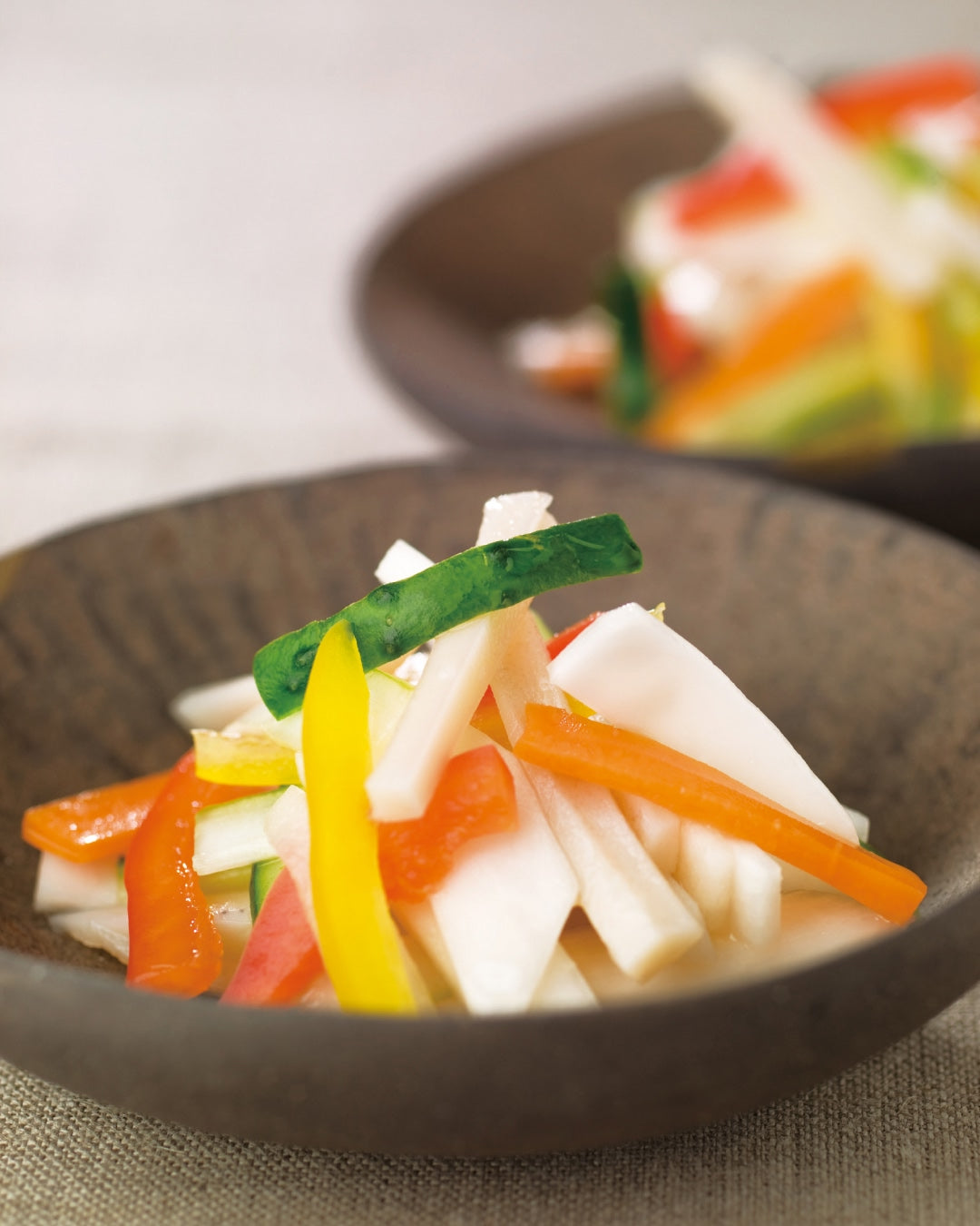 Colorful Japanese pickles with daikon, carrot, cucumber, and other vegetables served in a small bowl