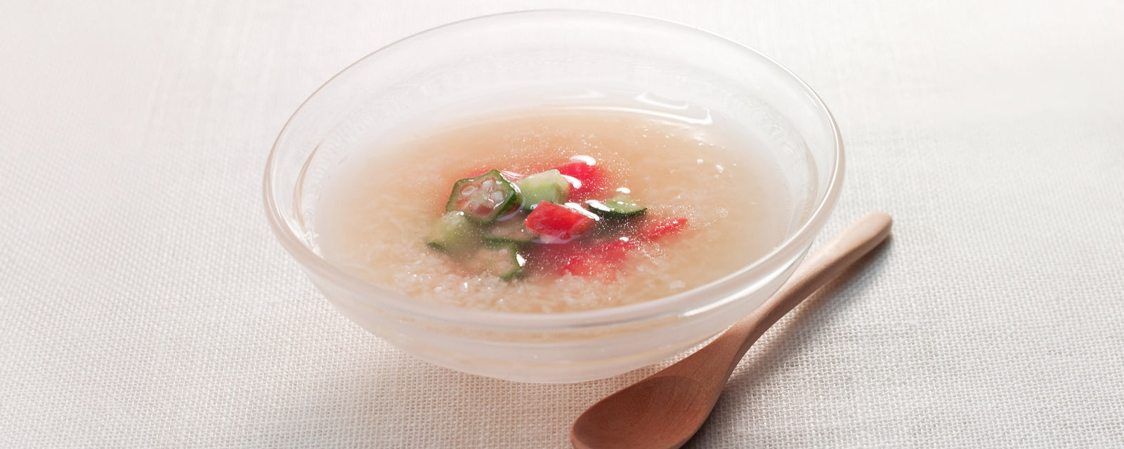 Chilled tororo soup topped with cucumber, tomato, and okra