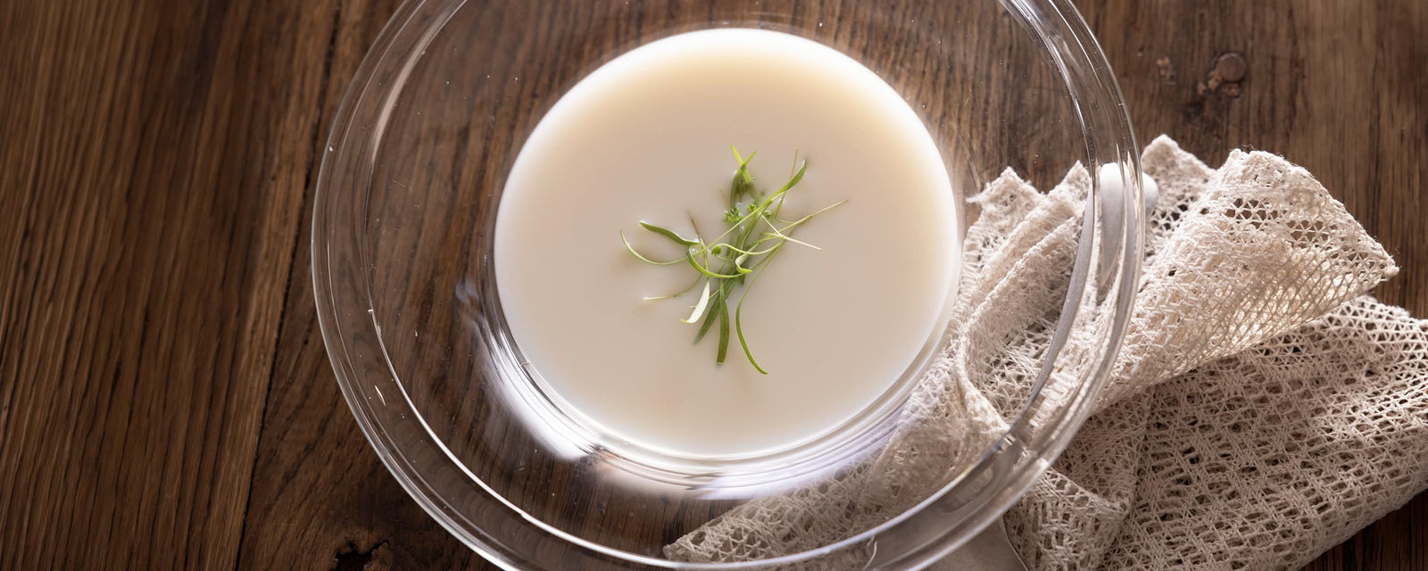Chilled Corn Dashi Milk Soup served cold and garnished with fresh herbs.