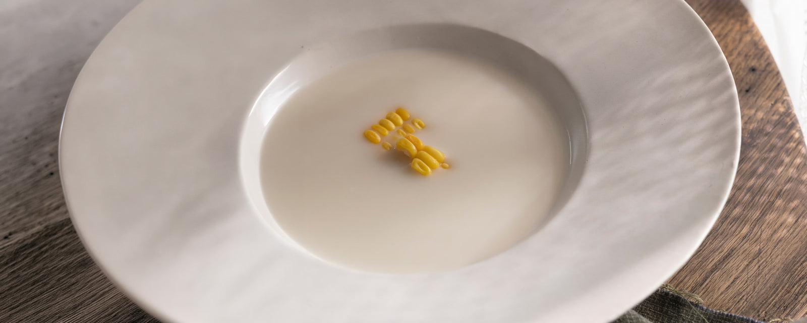 Corn Dashi Milk Soup with a smooth, creamy texture, garnished with sweet corn kernels.