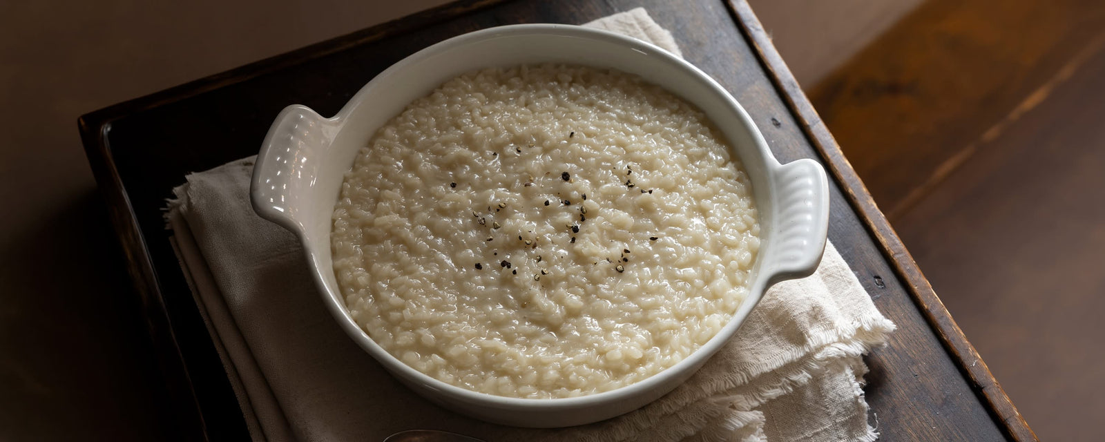 Creamy Cheese Risotto made with Corn Dashi, finished with butter, Parmesan cheese, and black pepper.