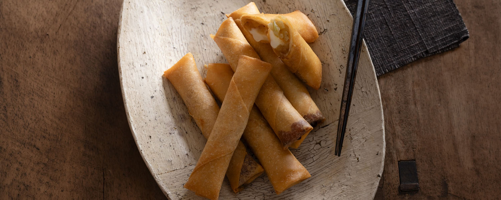 Crispy cheese spring rolls filled with onion and Corn Dashi, served as a savory Japanese-inspired appetizer.