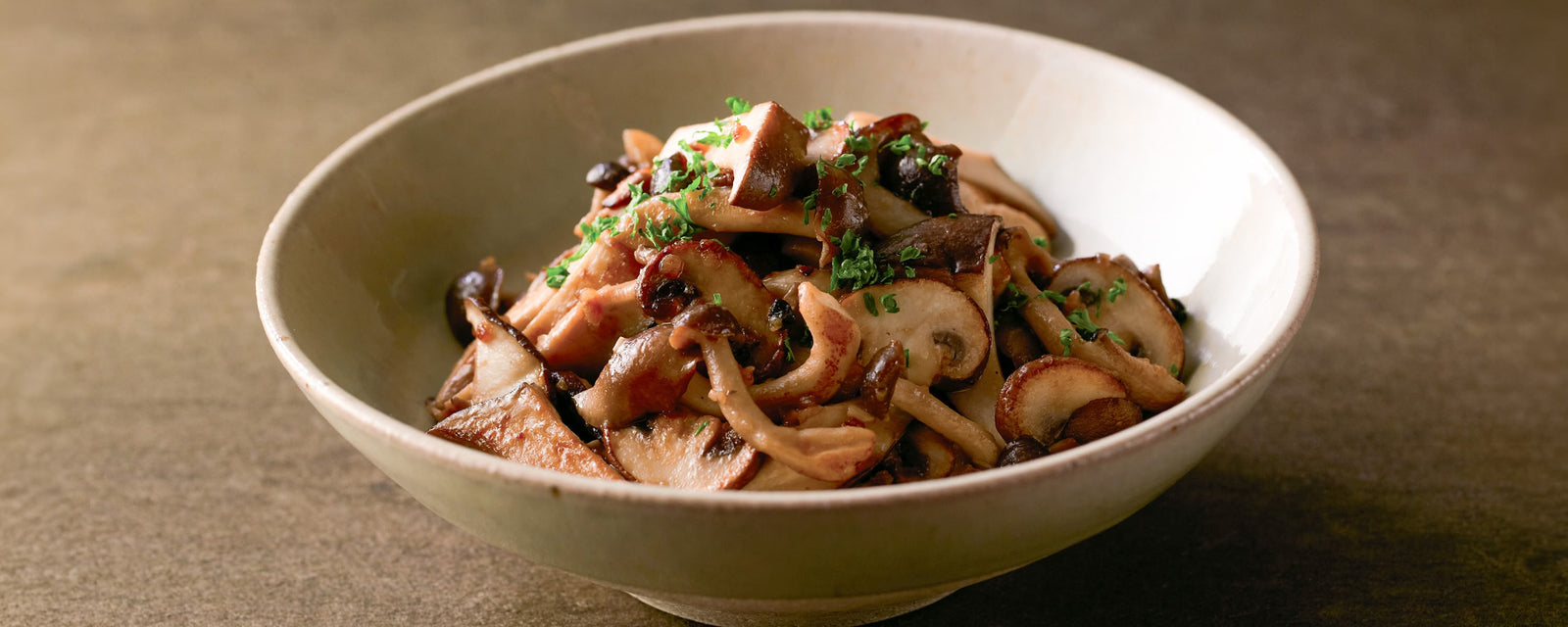 Butter-Sautéed Mixed Mushrooms made with Kayanoya Vegetable Stock Powder, garnished with chopped parsley.