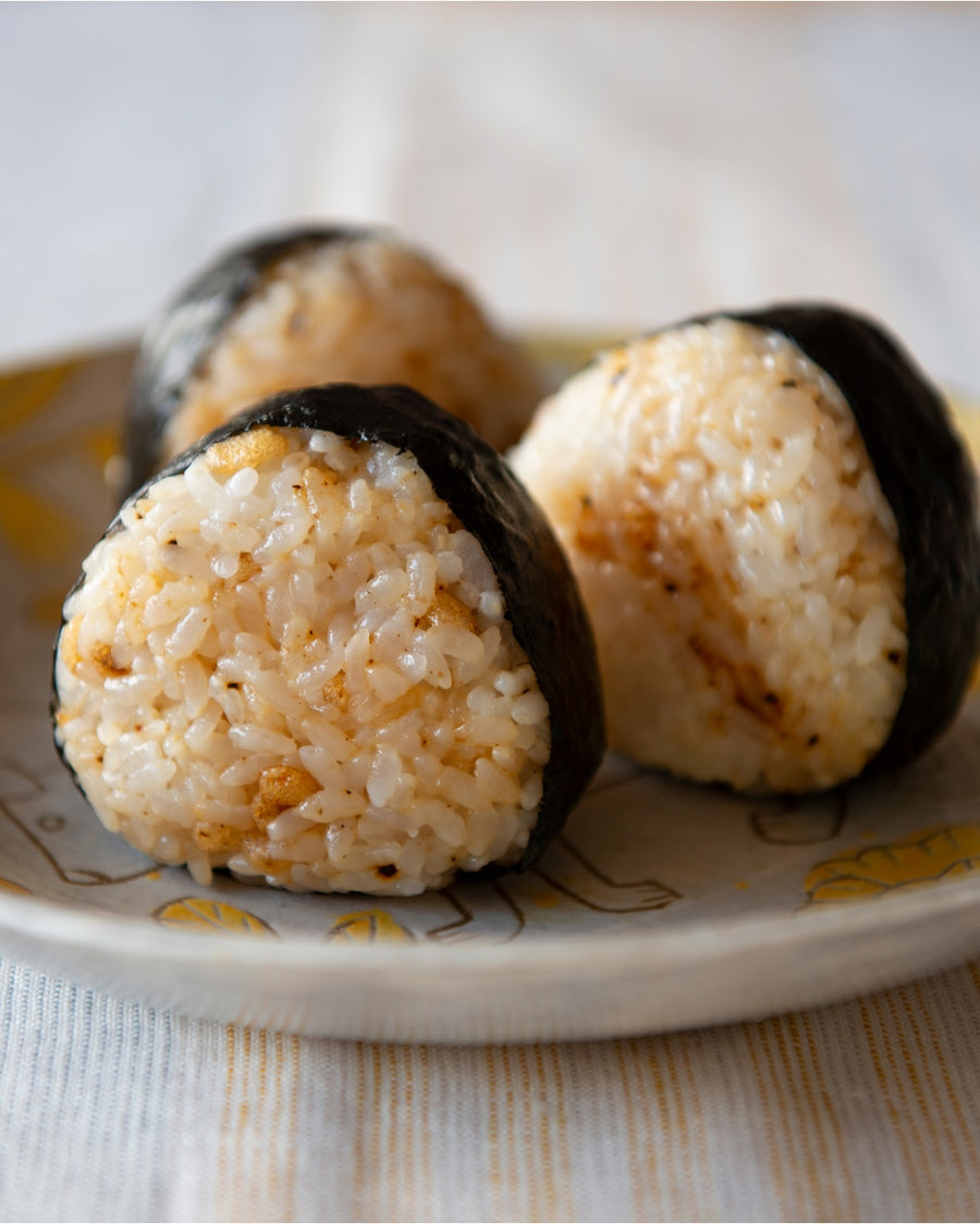 Grilled soy sauce onigiri (yaki onigiri) wrapped with nori on a small plate