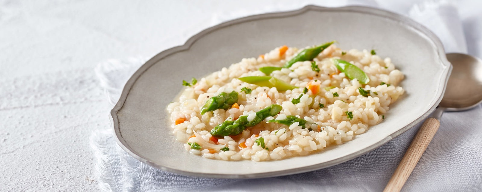 Dashi risotto with tender rice, asparagus, and finely chopped vegetables in a light savory broth