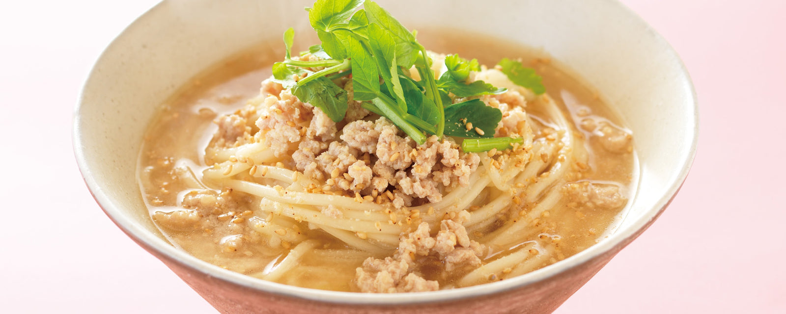 Non-spicy tantan udon with minced chicken, sesame-rich creamy dashi broth, and fresh Japanese parsley garnish 