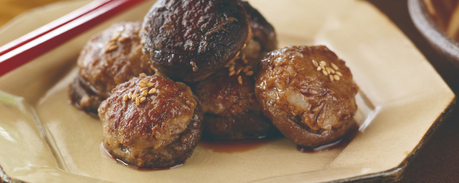 Meatballs stuffed with shiitake mushrooms and topped with sesame seeds