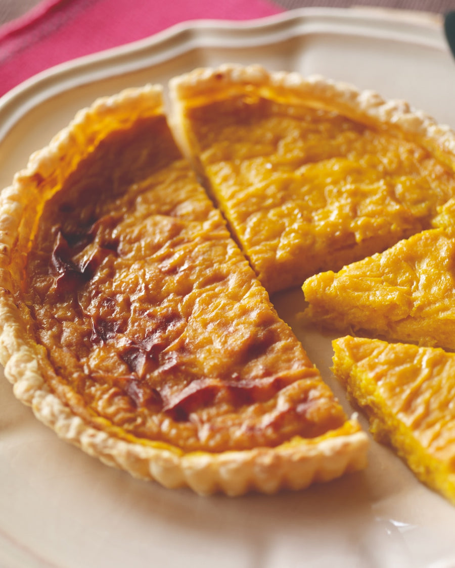Pumpkin tart sliced and served on a plate