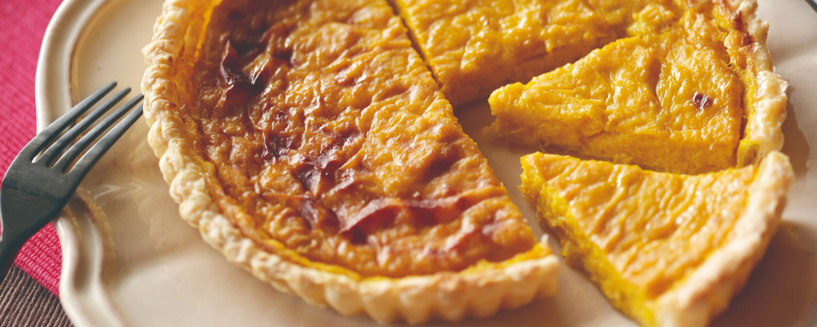 Pumpkin tart sliced and served on a plate