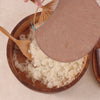 Cooling sushi rice with a fan in a wooden tub and covering it with a cloth to prevent drying.
